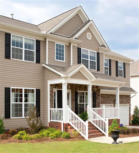 tan siding with black shutters